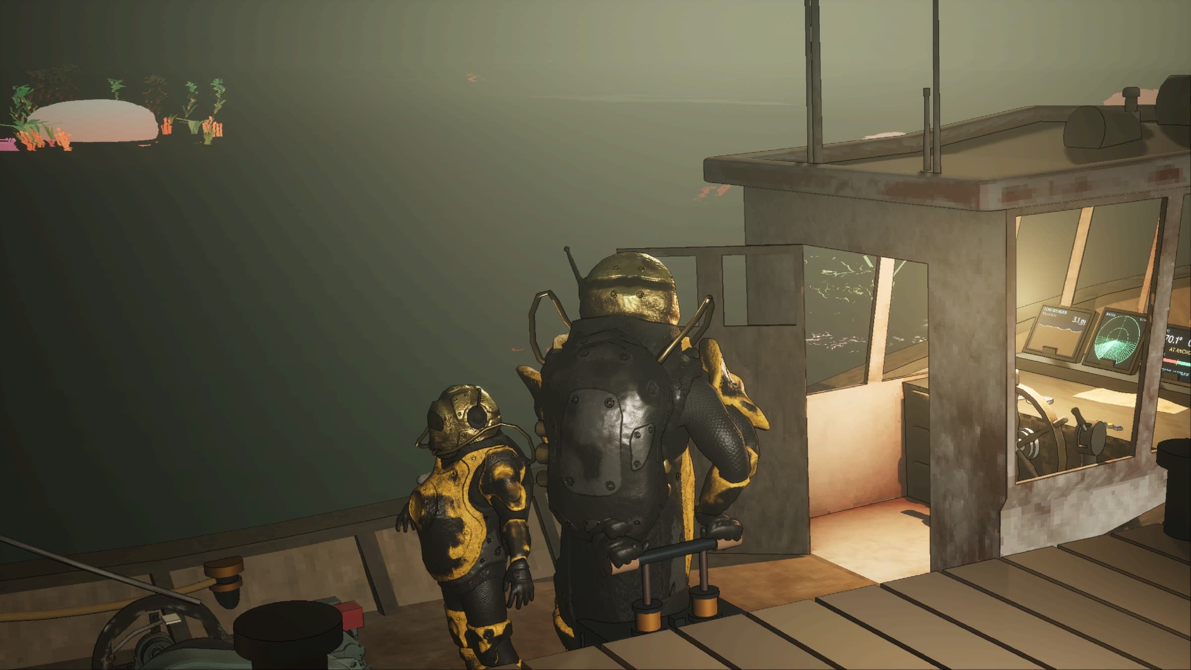 Two divers on a boat deck, one working an air pump.